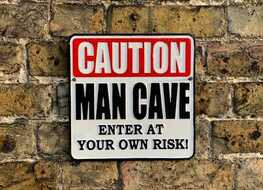 Caution man cave sign