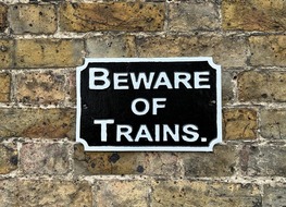 beware of trains sign